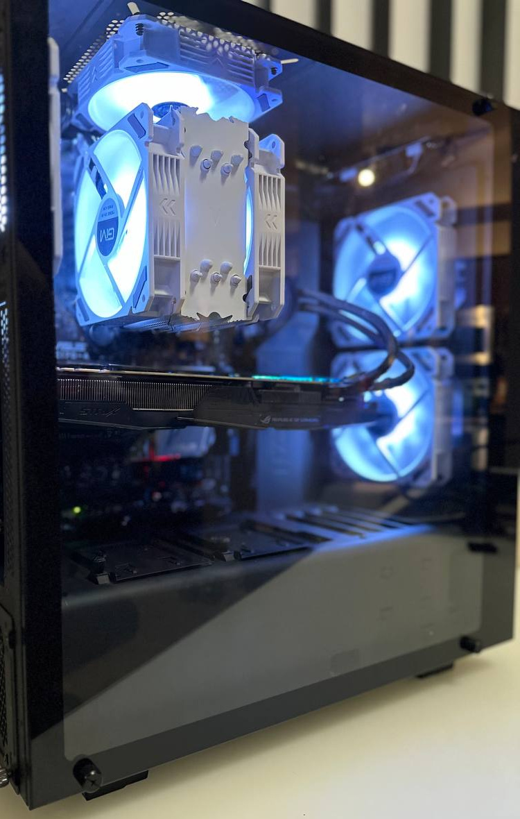 Angled black PC case with blue fans and a silver tower cooler