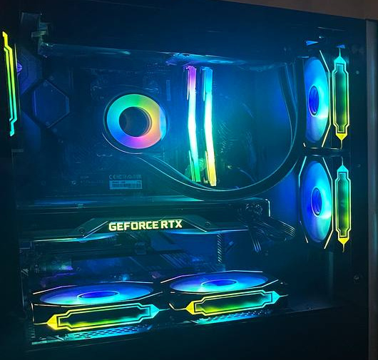 Black PC interior with multicolored fan rings, illuminated memory and a graphics card