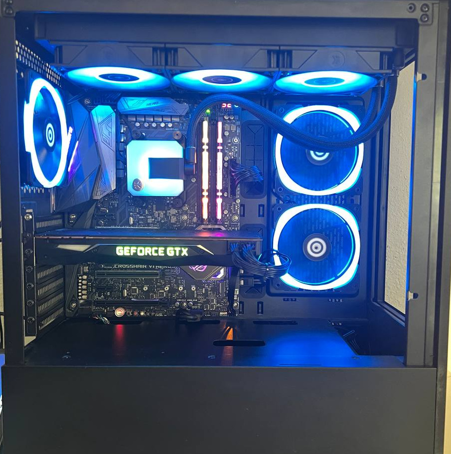 PC interior with blue top and front fan rings and a square processor cooler