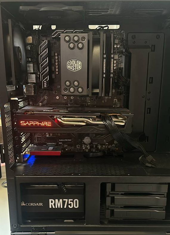 Black PC interior with tower cooler, graphics card and exposed power supply